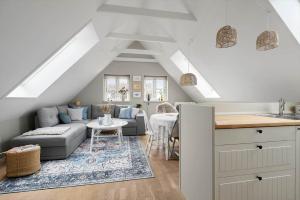 a living room with a couch and a table at 20430-Samso-Ballenvej-34A in Ballen