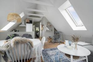 a white living room with a table and chairs at 20430-Samso-Ballenvej-34A in Ballen +15 photos