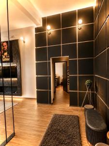 a room with a black wall with a doorway at Rebecca's Noir Suite in Reggio Emilia