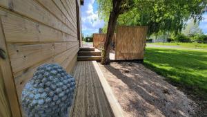 a building with a bunch of balls on the side of it at le verger des Sy Pommier in Picauville