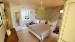 a bedroom with a large bed in a room at le verger des Sy Pommier in Picauville