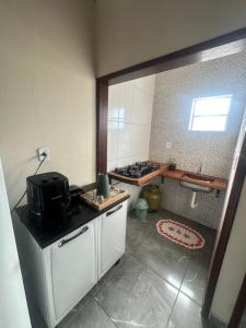 a kitchen with a stove and a counter top at Chalé do coiote 2 in São Roque de Minas