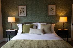 a bedroom with a bed with pillows and two lamps at The Marlborough Inn in Marlborough