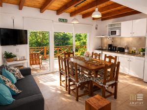 a kitchen and dining room with a table and chairs at Amutuy Bariloche in San Carlos de Bariloche