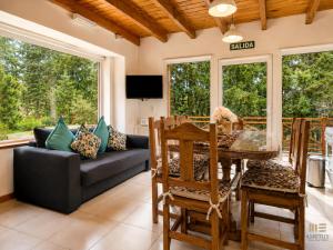 a living room with a table and a couch at Amutuy Bariloche in San Carlos de Bariloche