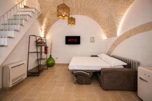 a hospital room with a bed and stairs at Martine Dimore Storiche di Puglia in Martina Franca