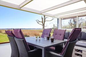 a table and chairs on a patio with a view of a field at 14250-Grevinge-Hybenvaenget-9 in Grevinge