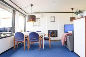 a living room with a dining room table and chairs at 14250-Grevinge-Hybenvaenget-9 in Grevinge