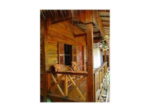 a porch of a wooden house with a balcony at Om Home in Sihanoukville