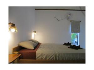 a bedroom with a bed and a lamp at Om Home in Sihanoukville