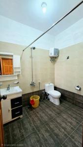 a bathroom with a sink and a toilet in a room at Nathia Lodge Cottage in Nathia Gali +46 photos