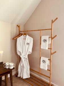 a room with a towel rack and two towels at Everwood Escape- The Willow Hut With Private Hot Tub in Dungiven