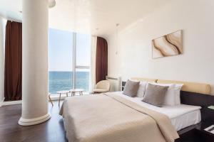 a hotel room with a bed and a large window at Boutique Hotel Portofino in Odesa +192 photos