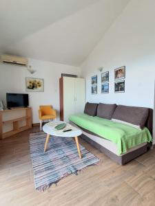a living room with a bed and a coffee table at Resort "Maslinjak" in Budva