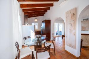 a kitchen and dining room with a table and chairs at Villas Finesse By MENORCARENTALS in Son Bou