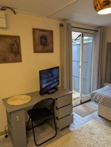 a bedroom with a desk with a computer on it at Private Studio Anex in Sherborne Saint John
