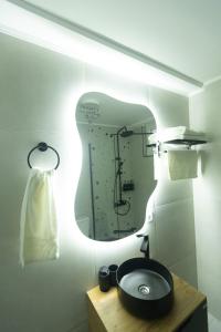 a bathroom with a sink and a mirror at Bitola Stay in Bitola +18 photos