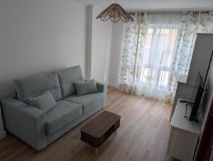 a living room with a couch and a table at Mosquera House in Arzúa