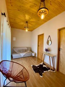 a room with a bed and a chair and a table at Casa Araucária in Cunha