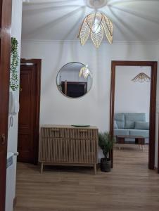 a living room with a mirror and a blue couch at Mosquera House in Arzúa +7 photos