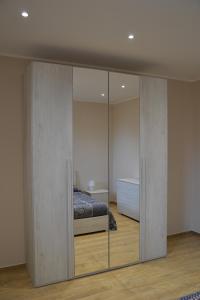 a bedroom with a bed and a sliding glass door at Casa RUDOM in Aci SantʼAntonio