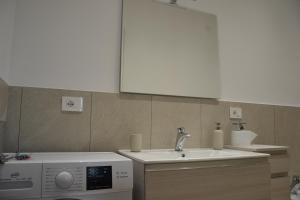 a kitchen with a sink and a washing machine at Casa RUDOM in Aci SantʼAntonio +31 photos