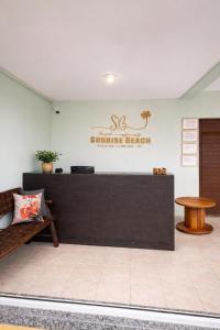 a reception desk in a room with a table at Pousada Sunrise Beach in Cumbuco +48 photos