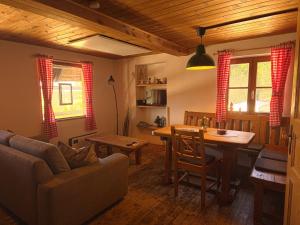 a living room with a couch and a dining room table at miki Hütten in Pack