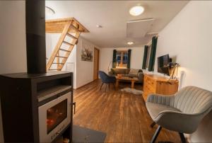 a living room with a fireplace and a couch at miki Hütten in Pack