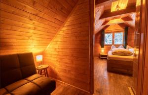 a room with a bed and a couch in a cabin at miki Hütten in Pack