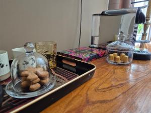 a table with a tray of cookies and a glass jar at Villa Oasis in Lelystad