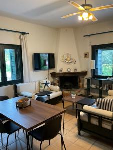 a living room with a couch and a table at Polyxeni villa - Neo Klima in Skopelos Town