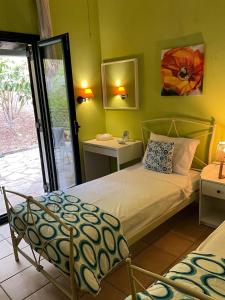 a bedroom with a bed and a door to a patio at Polyxeni villa - Neo Klima in Skopelos Town