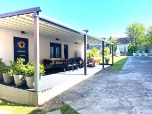 a covered patio with a table and chairs at Petite Mansion in Našice