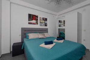 a bedroom with two beds with towels on them at Villa Aurora in Ohrid +40 photos