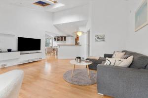 a living room with a couch and a table at 84265-Ega-Strandvangsvej-27 in Skæring