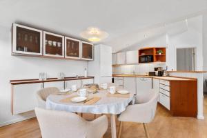 a kitchen with a table and chairs in a room at 84265-Ega-Strandvangsvej-27 in Skæring