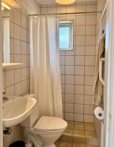 a white bathroom with a toilet and a sink at 20432-Samso-Klintevej-6 in Ballen +27 photos