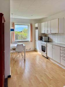 an empty kitchen with a table and a window at 20432-Samso-Klintevej-6 in Ballen
