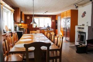 a kitchen with a long wooden table and chairs at GOT698-Laerbro-Rute-Sofiero-133 in Lärbro