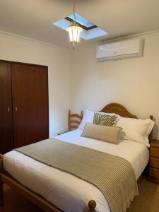 a bedroom with a bed with a ceiling fan at Casa D Dinis in Alfaiates
