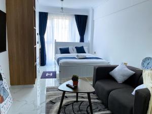 a living room with a bed and a couch at Sasha BnBs in Nairobi +74 photos