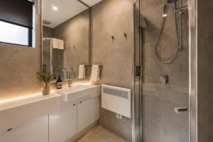 a bathroom with a shower and a sink and a glass shower stall at Black Sheep alpine getaways in Dinner Plain
