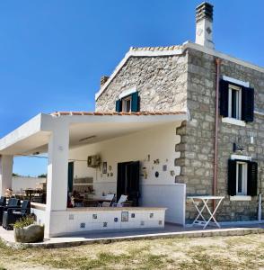a stone house with a view of the backyard at Sweet Home Spalmatore in Carloforte