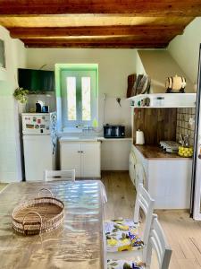 a kitchen with a table and chairs and a counter at Sweet Home Spalmatore in Carloforte +2 photos