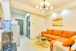 a living room with a couch and a table at Sasha BnBs in Nairobi