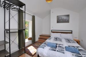 a bedroom with a bed with blue pillows at Hollins Lodge in Grosmont