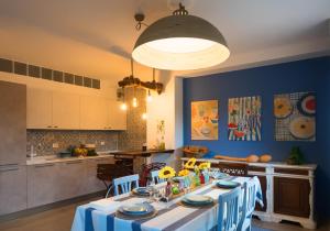 a kitchen with a table with a blue wall at In ta Villa da u Perinetti in Bastia