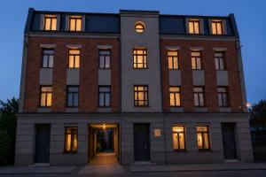 a large brick building with its doors open at INSEN Apartamenty Manufaktura Sauna i Masaże Apartament Superior in Łódź +23 photos