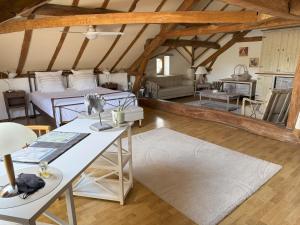 a bedroom with two beds and a living room at En bord de rivière in Casseneuil